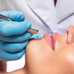Permanent lip makeup procedure is carried out