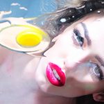 A raw egg floats against the background of a beautiful girl